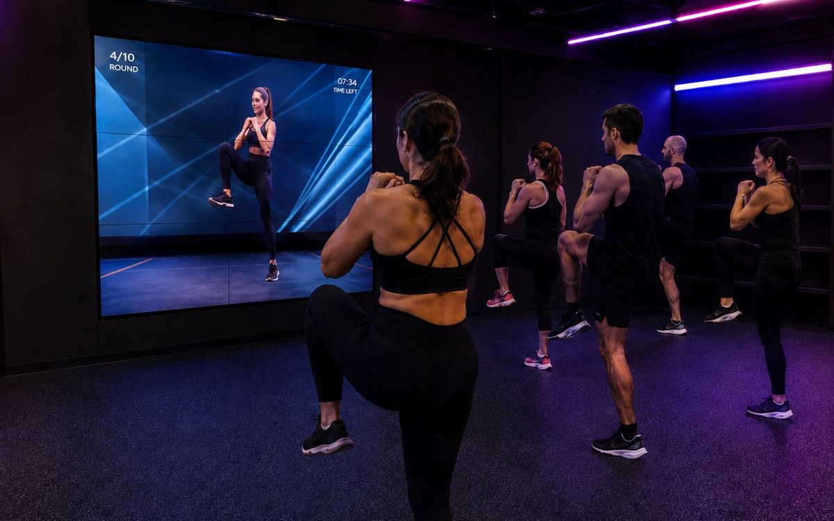Turma a seguir um treino mostrado num grande ecrã